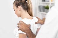 male-physiotherapist-checking-woman-s-back-shoulders_web